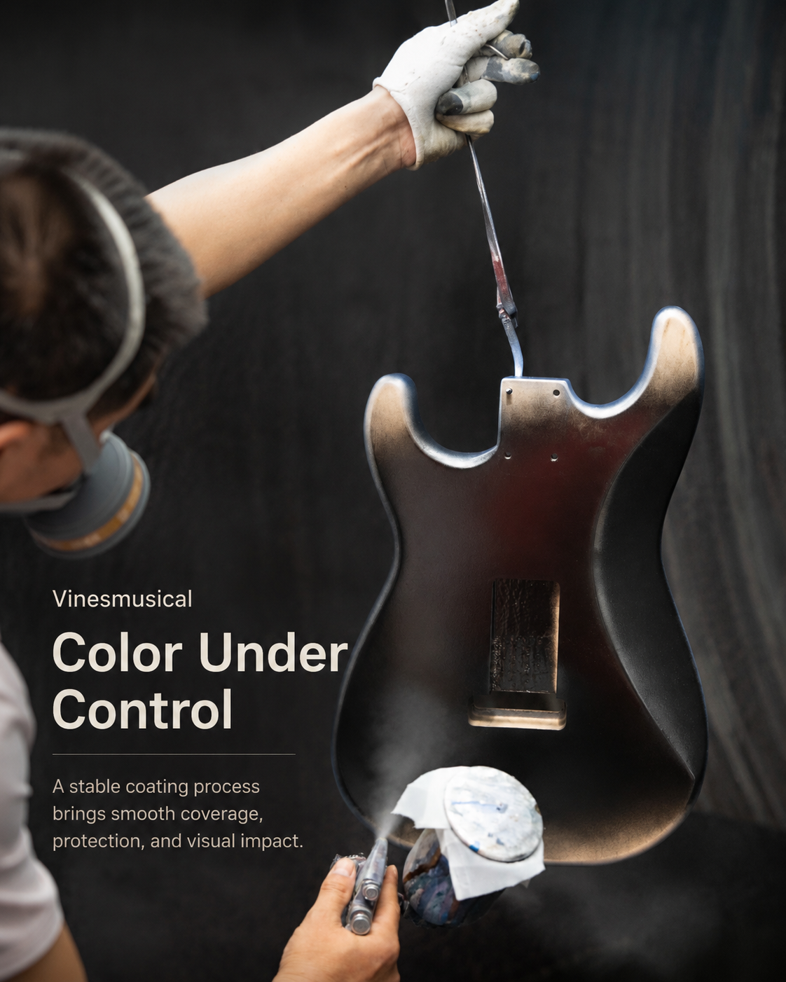 Worker spraying color on an electric guitar body in the factory